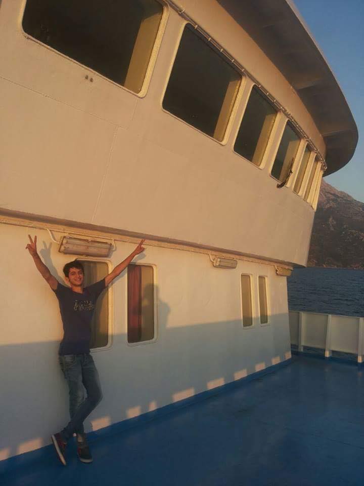 Muhammad raising the victory sign while sailing to Athens from the island of Samos.