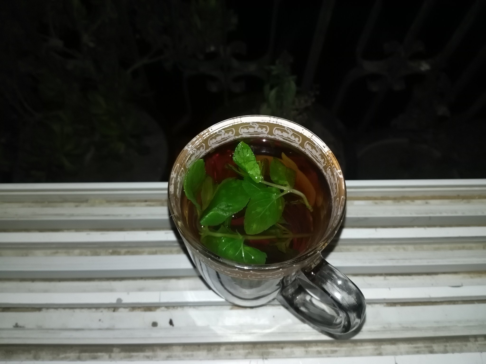 a mug of tea with mint leaves