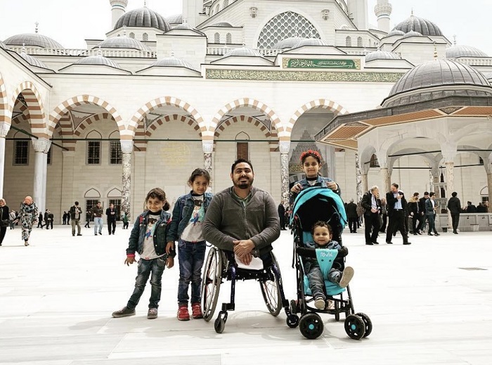 family in front of mosque