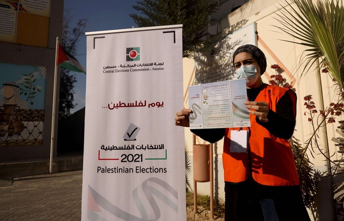 woman holding up campaign flyer