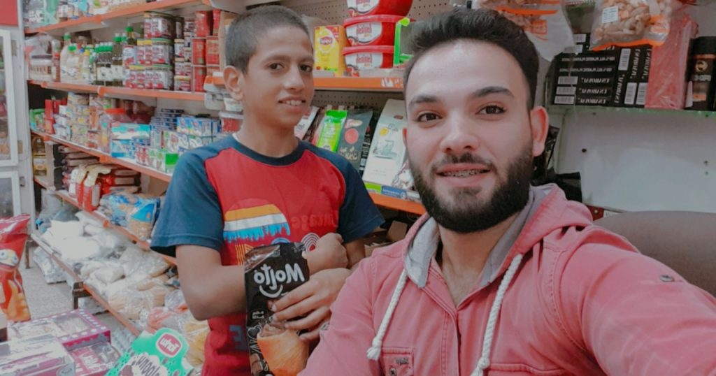 Young man with boy in a store.