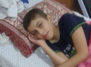 Boy lying on bed.