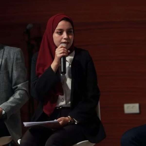 young woman speaking into microphone