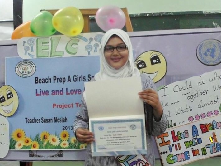 young girl holding middle school certificate