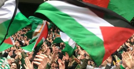 Palestinian flags fly at soccer match