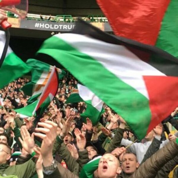 Palestinian flags fly at soccer match