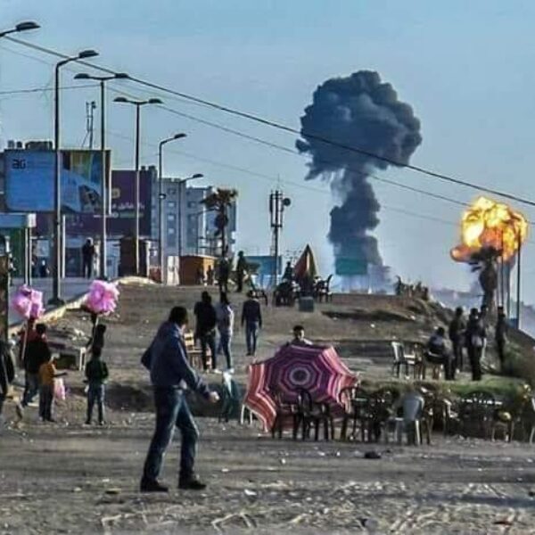 Rafah beach with explosion in background.