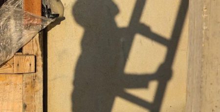 shadow of boy climbing ladder