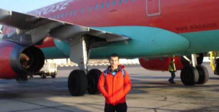 young man in front of airplane