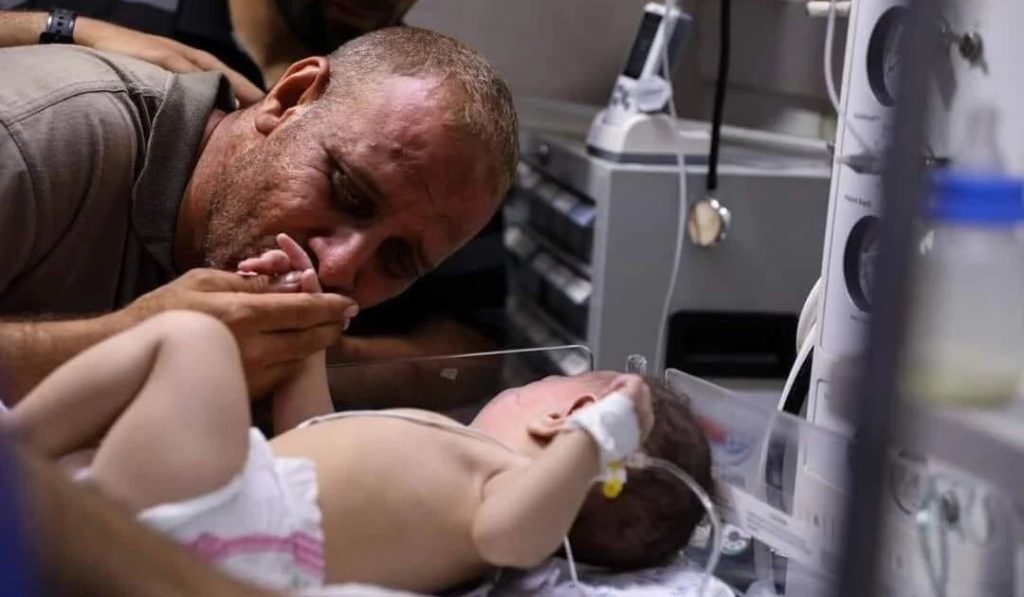 father kissing injured infant