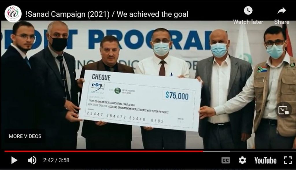 Men holding up an oversized check.