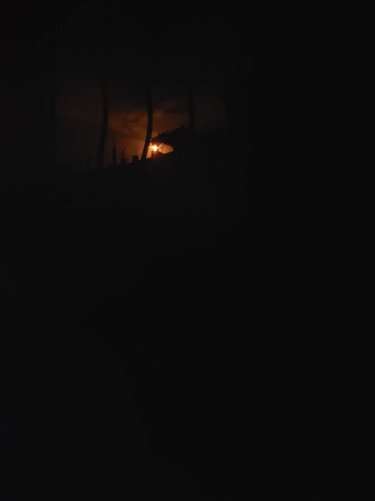 explosion glowing through a window.