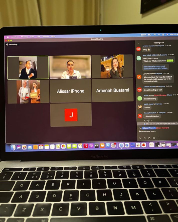 laptop screen showing participants in an online meeting.