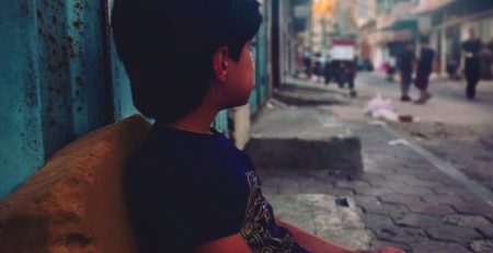 Boy waiting on Gaza street.