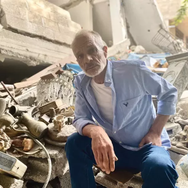 Hazem Muhanna sits amid the rubble of his home