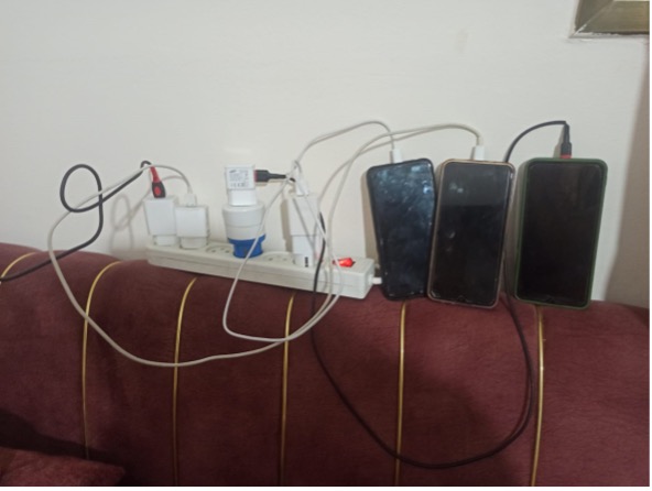 Several phones plugged in to get a charge.