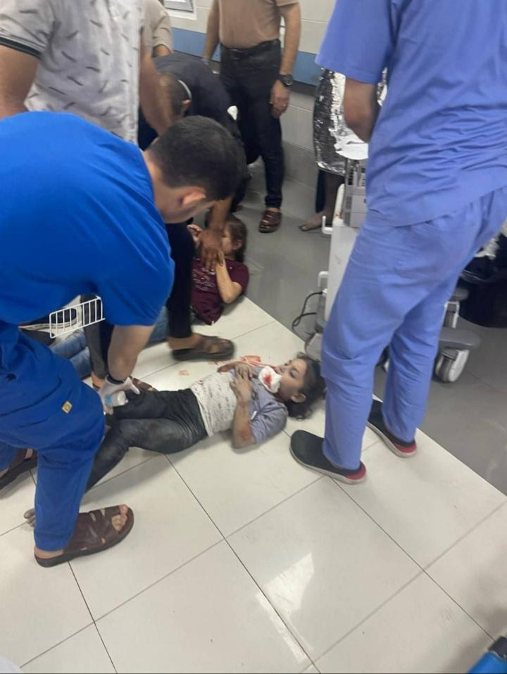 Nurse treating child in Al-Shifa Hospital.