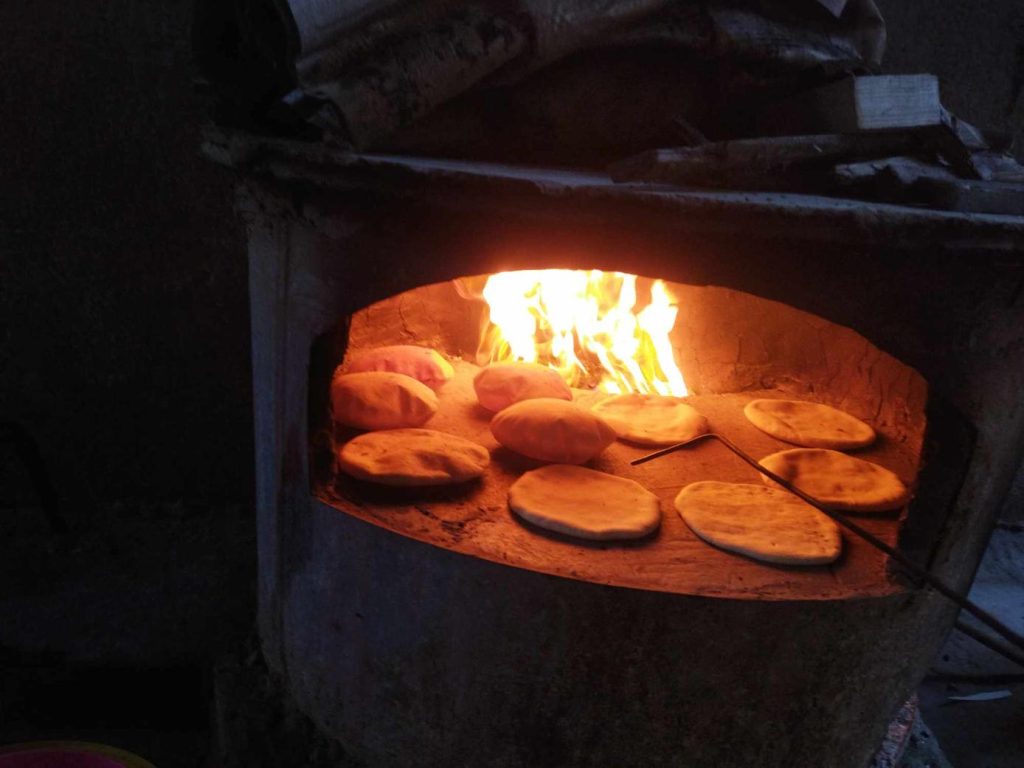 Bread baking in rudimentary woodfired oven in Gaza.