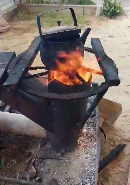 Kettle on hand-constructed wood-fired stovepipe, in war-torn Gaza.