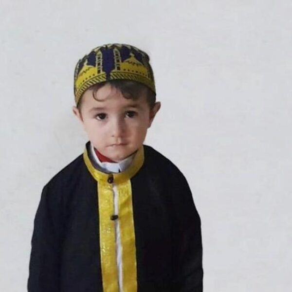 3-year-old boy in formal cap and jacket.
