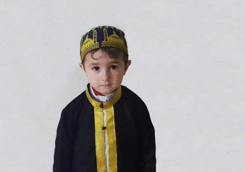 3-year-old boy in formal cap and jacket.