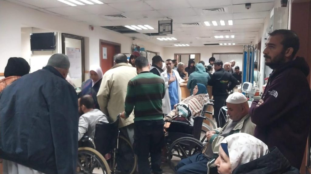 Crowded hospital waiting area at Al-Aqsa Hospital, Gaza.