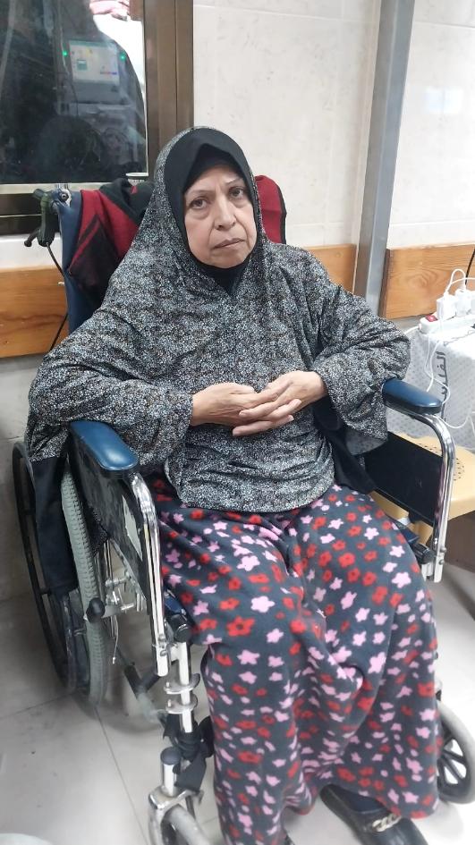 Woman in wheelchair in hospital waiting area.