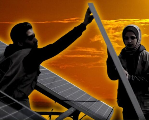 Young man and woman installing a solar panel.