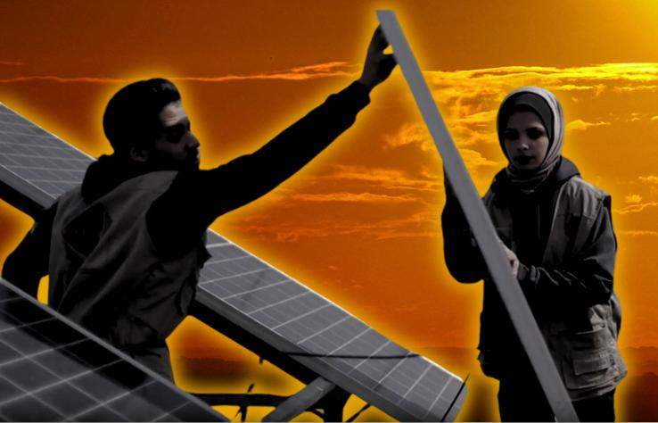 Young man and woman installing a solar panel.