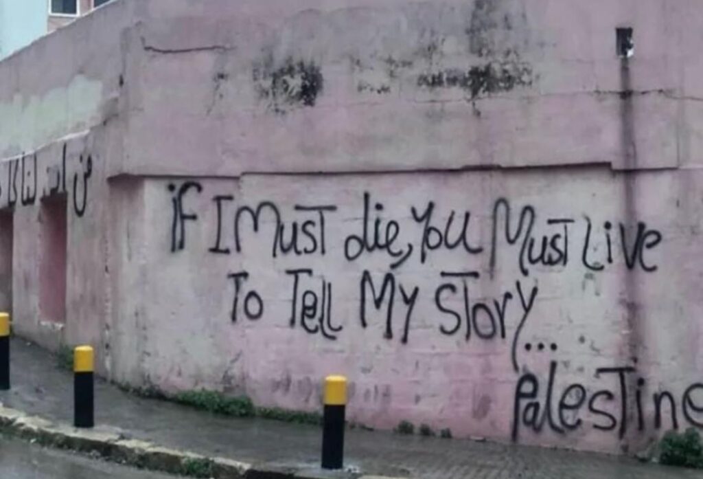 Graffit on wall: "If I must die, you must live to tell my story."