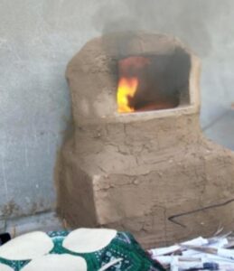 Clay oven with smoke coming out.