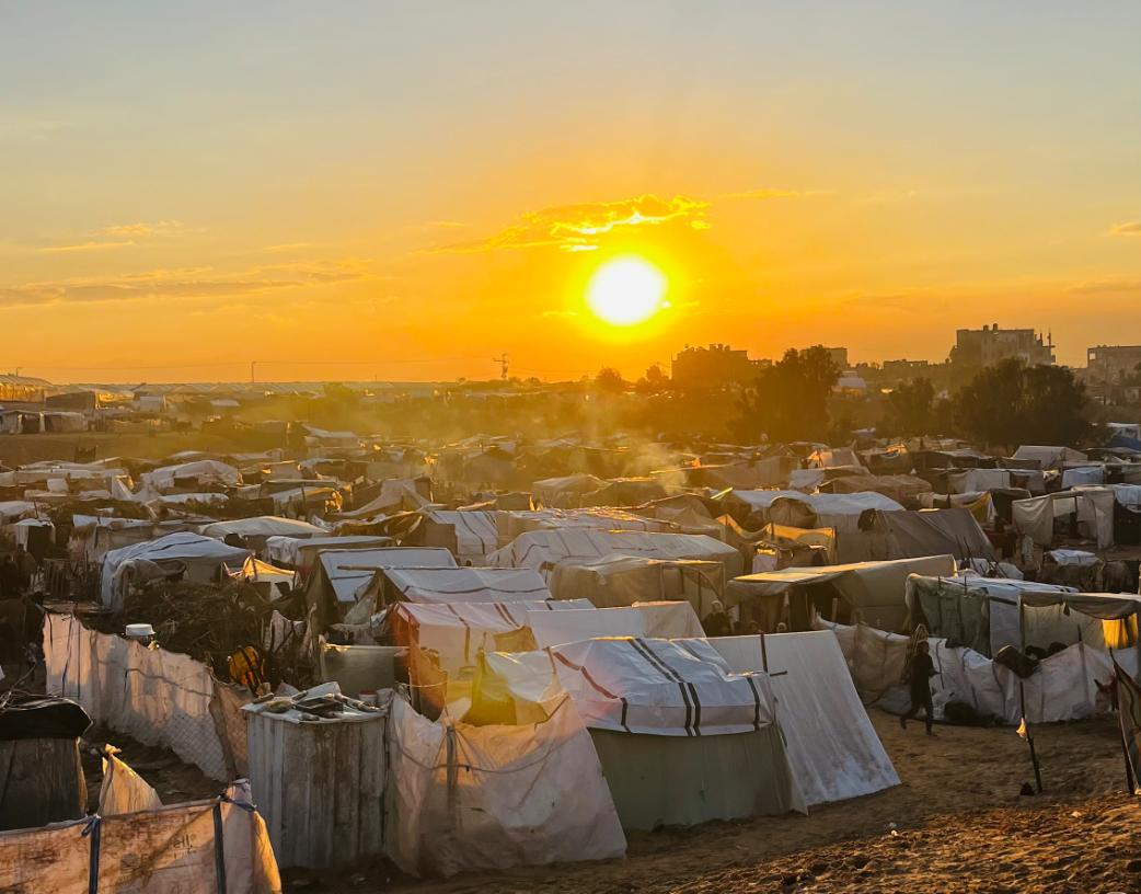 Tent camp in Rafah, with strong sun.