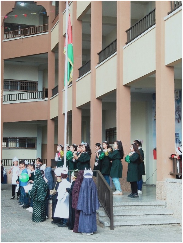 Students and teachers in front of school.